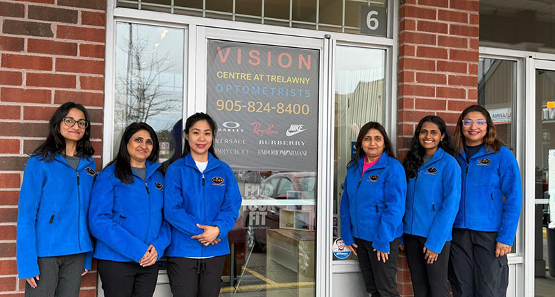 team outside front door of clinic